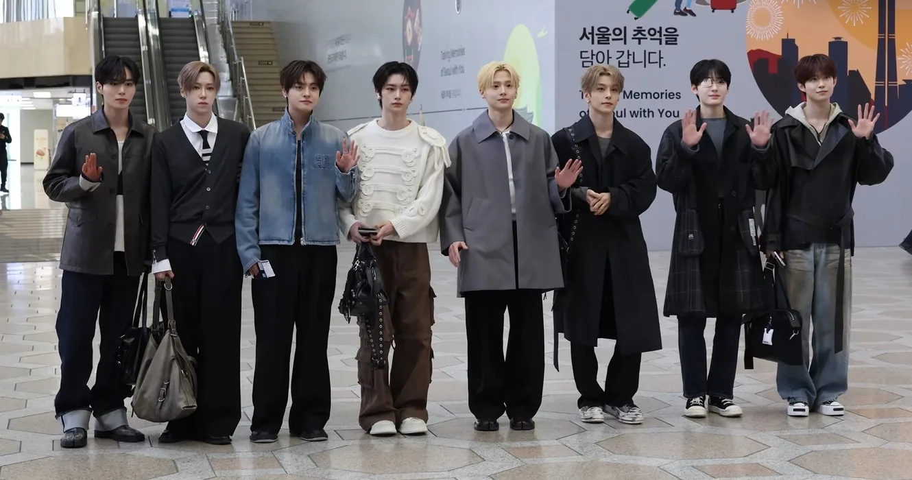 All eight ALPHA DRIVE ONE members posing at an airport on March 12, 2026