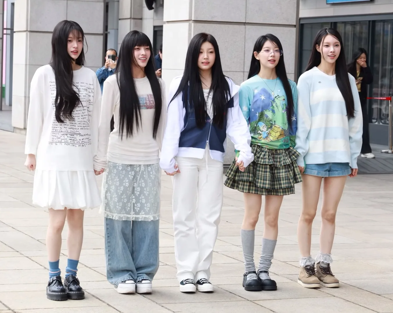 Illit on the way to a radio show in March 2024, days after their debut