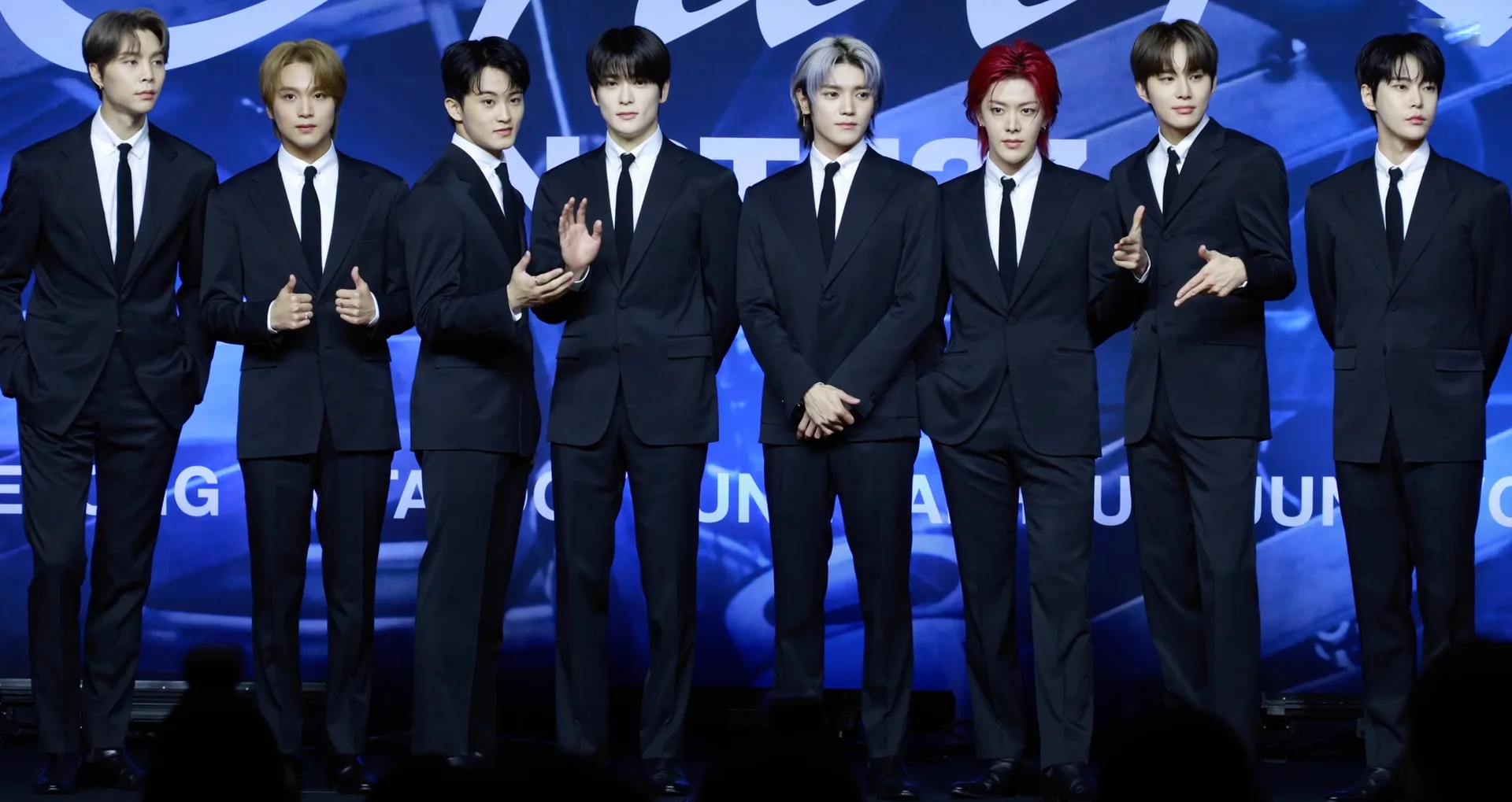 NCT 127 at the Fact Check press conference in October 2023, including former member Mark