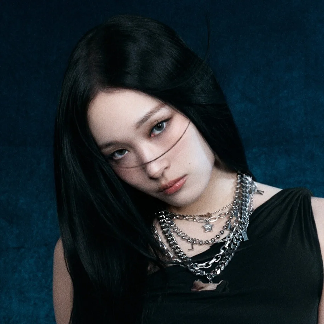 Annie of ALLDAY PROJECT in an official blue-background portrait