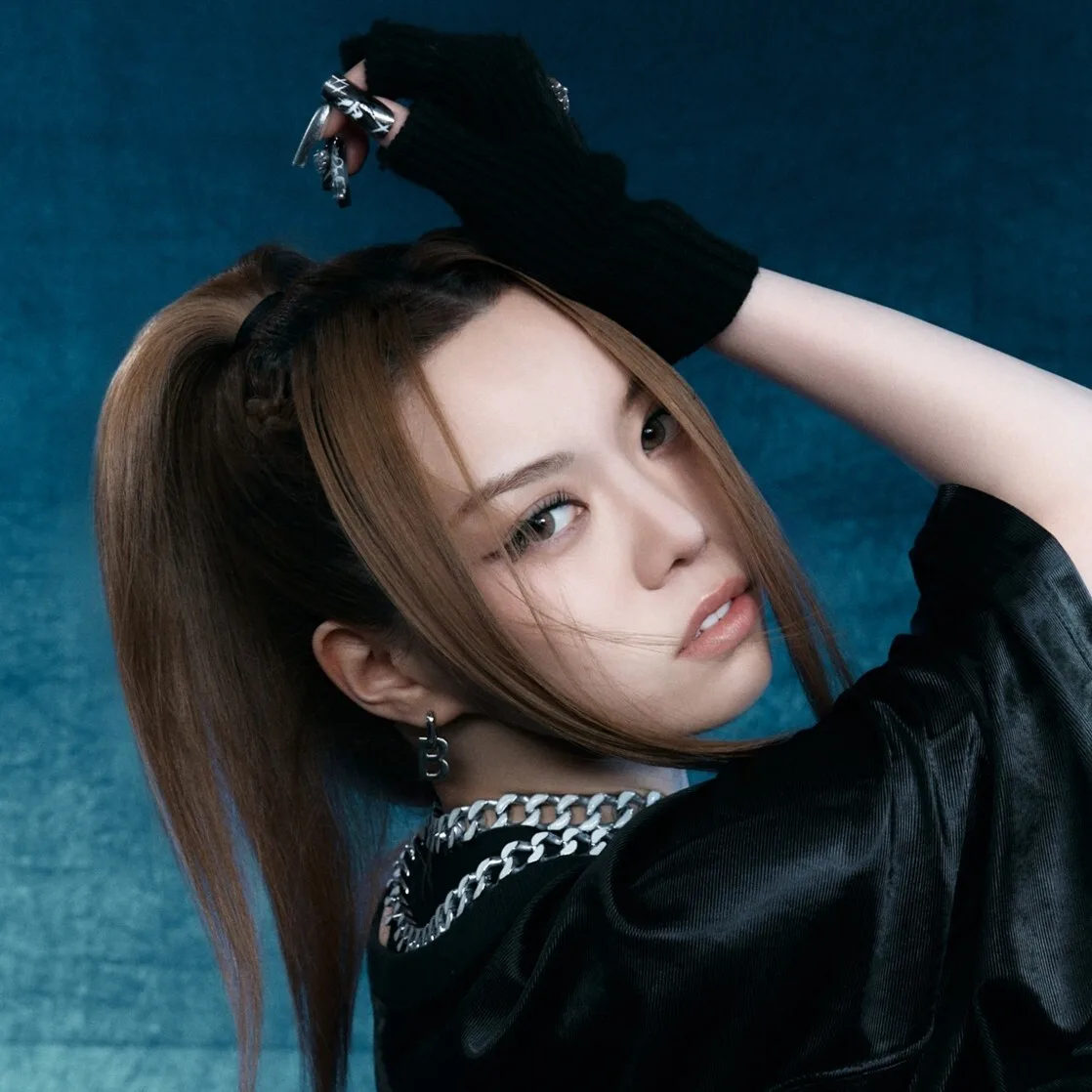 Bailey of ALLDAY PROJECT in an official blue-background portrait