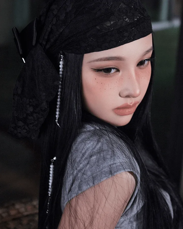 Chenyu of A2O MAY in a black lace headscarf and grey top, in her official profile portrait
