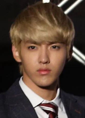 Kris, former EXO-M member, in a dark jacket and tie
