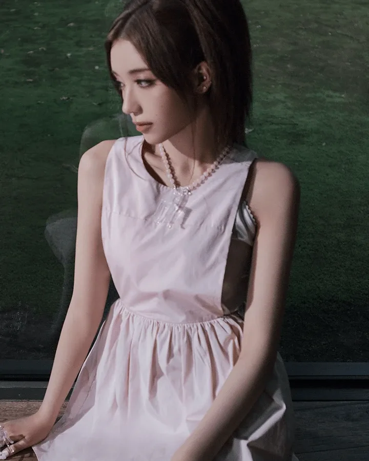 Miche of A2O MAY in a pale pink sleeveless dress, seated, in her official profile portrait