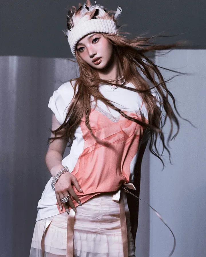 Shijie of A2O MAY in a knit cap and pink layered top with long wavy hair, in her official profile portrait