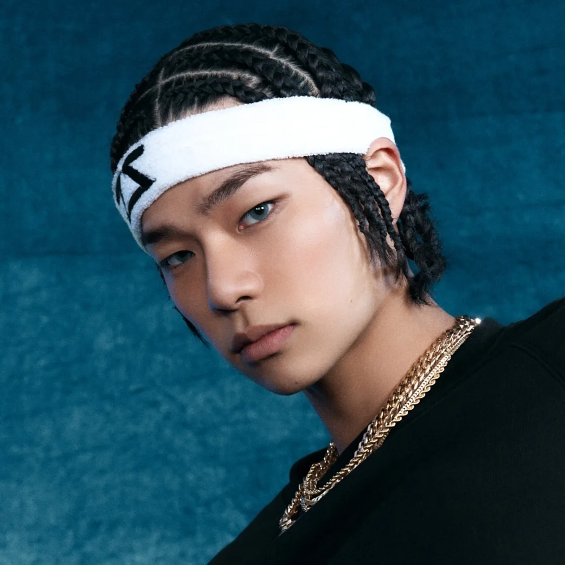 Tarzzan of ALLDAY PROJECT in an official blue-background portrait