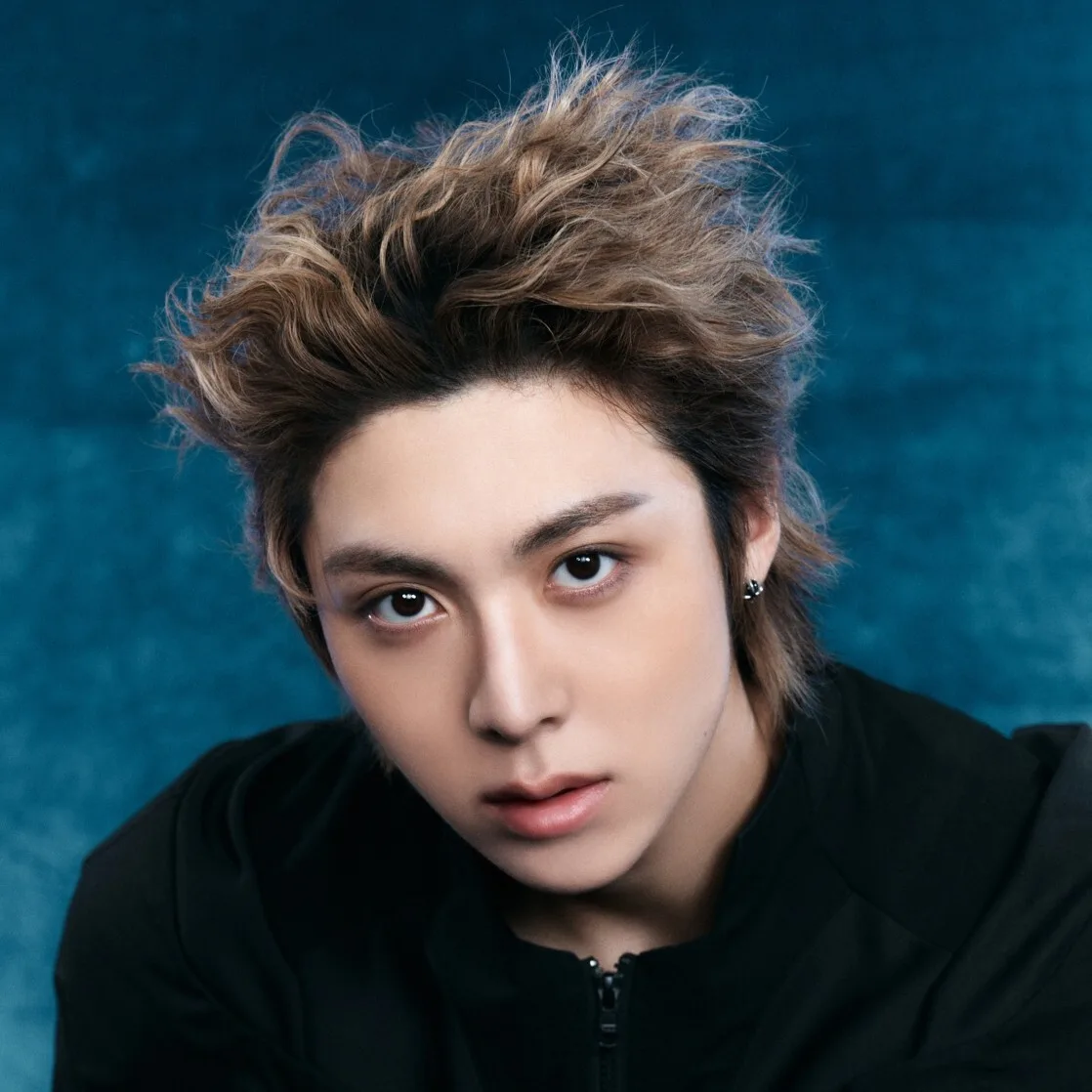 Woochan of ALLDAY PROJECT in an official blue-background portrait
