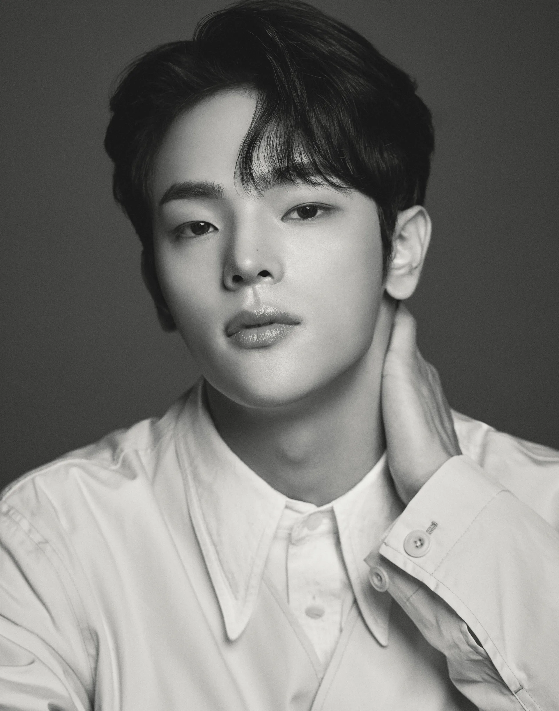 Kim Woojin in an official black-and-white Kustomade portrait